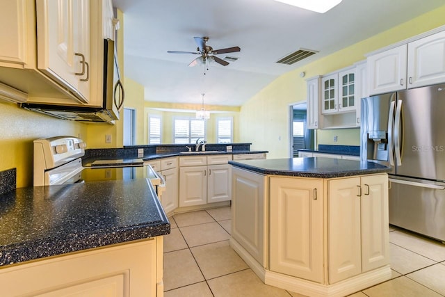 kitchen with kitchen peninsula, a center island, lofted ceiling, and appliances with stainless steel finishes