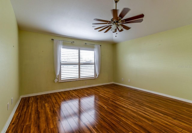 unfurnished room with ceiling fan and dark hardwood / wood-style flooring