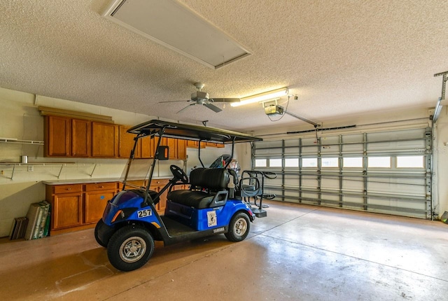 garage with ceiling fan and a garage door opener