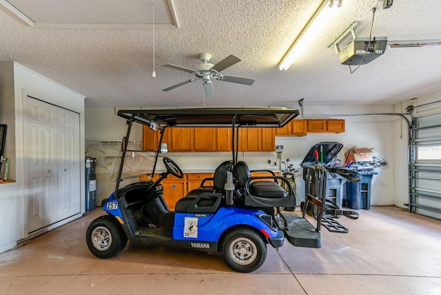 garage with ceiling fan, electric water heater, and a garage door opener