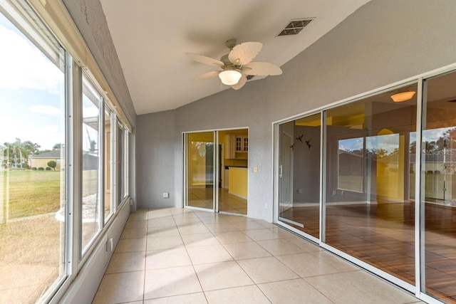 unfurnished sunroom with ceiling fan and lofted ceiling