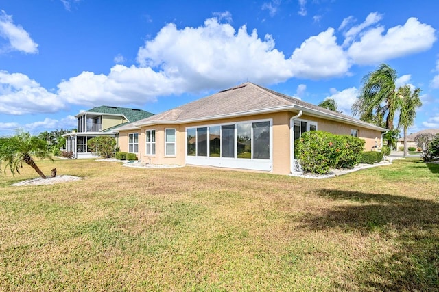 back of house featuring a lawn