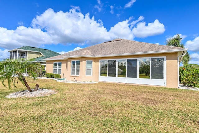 back of house with a lawn