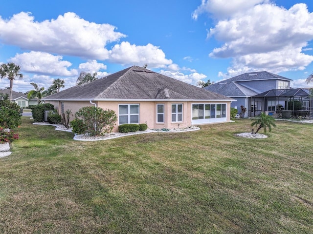 rear view of property featuring a yard