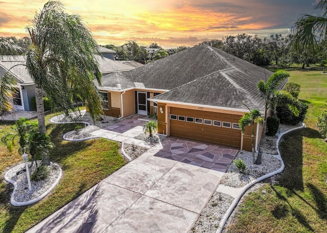 ranch-style home with a lawn and a garage