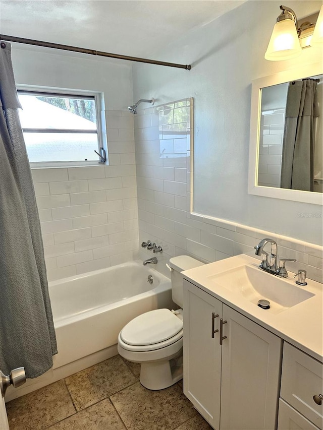 full bathroom featuring vanity, shower / bath combination with curtain, tile walls, and toilet