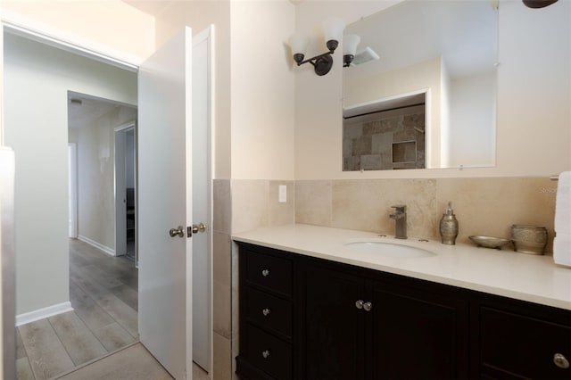 6701 13th Ave N, Saint Petersburg, FL 33710 - bathroom with vanity, tasteful backsplash, wood finished floors, and baseboards