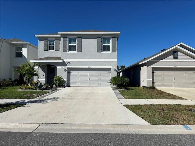 view of front of house featuring a garage and a front lawn