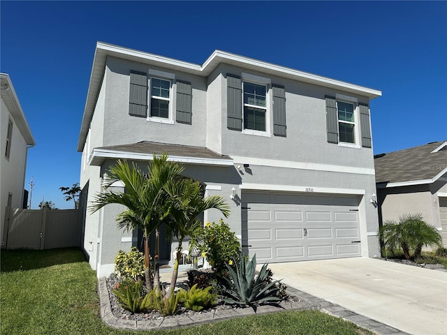 view of front of home featuring a garage, fence, concrete driveway, and stucco siding