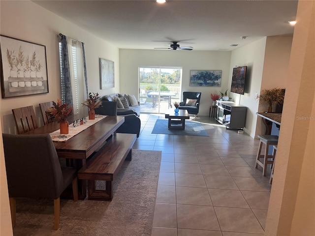 dining space featuring ceiling fan and light tile patterned floors