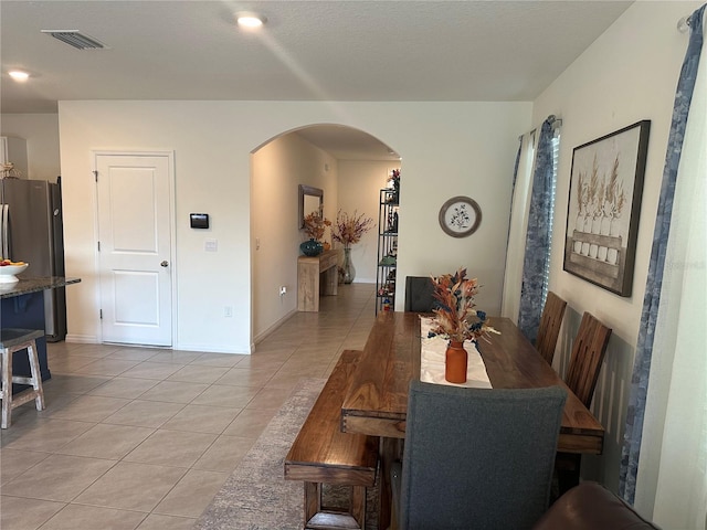 dining space featuring light tile patterned floors