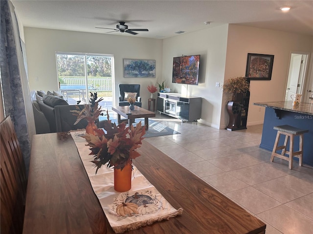 living room featuring ceiling fan and light tile patterned floors