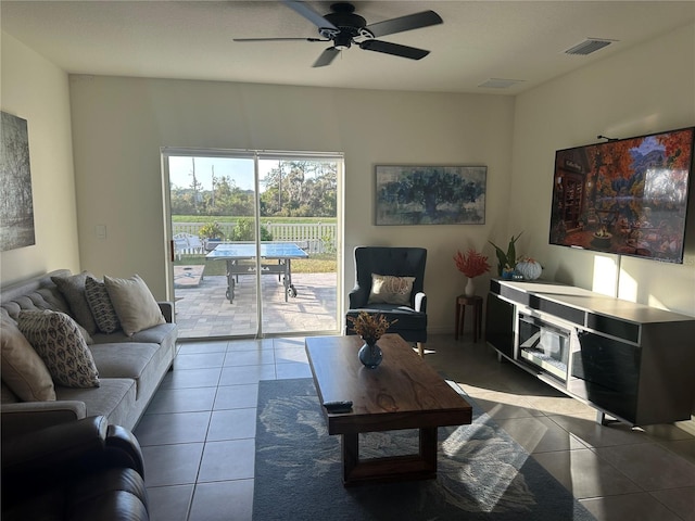 living room featuring tile patterned floors and ceiling fan