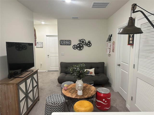 carpeted living room featuring a textured ceiling