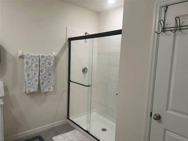 bathroom featuring tile patterned flooring and an enclosed shower