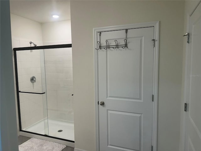 bathroom featuring a shower with shower door