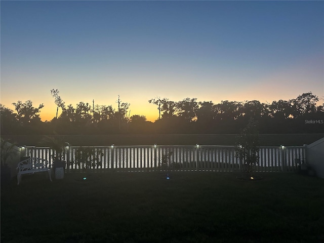 view of yard at dusk