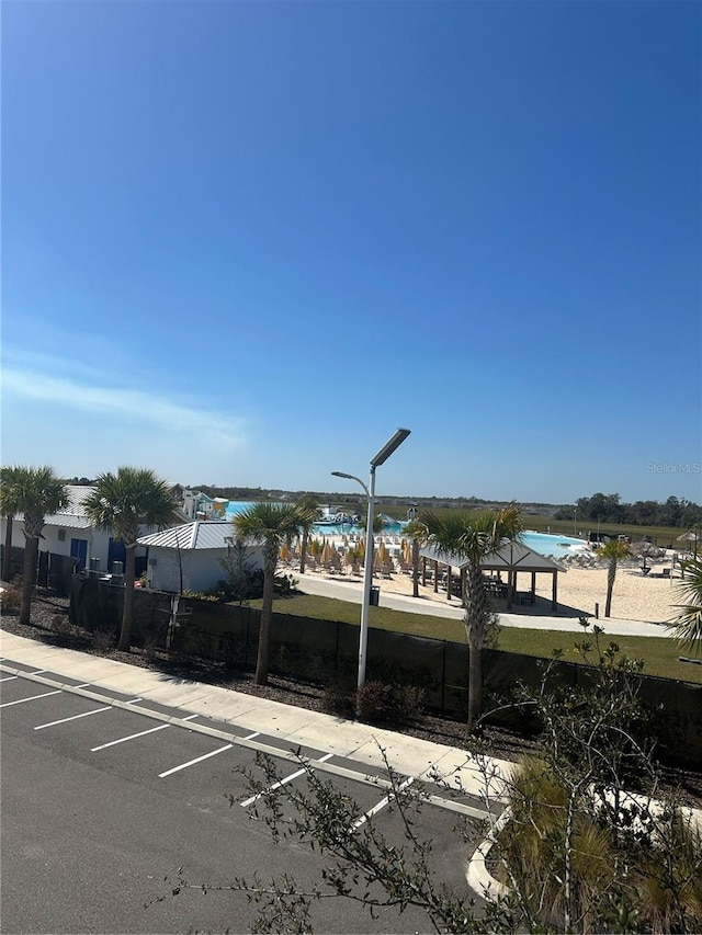 view of car parking featuring a water view