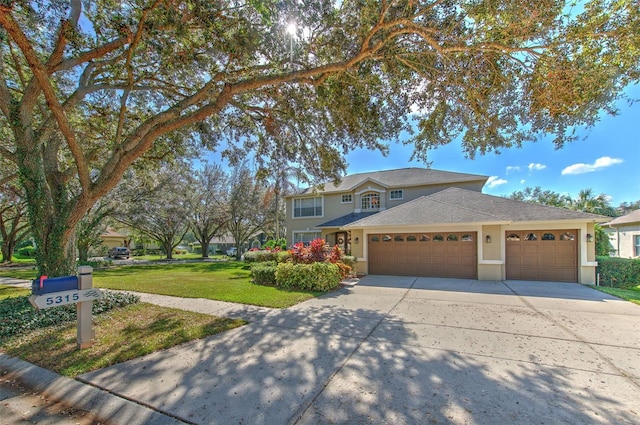 view of front of home with a garage and a front yard