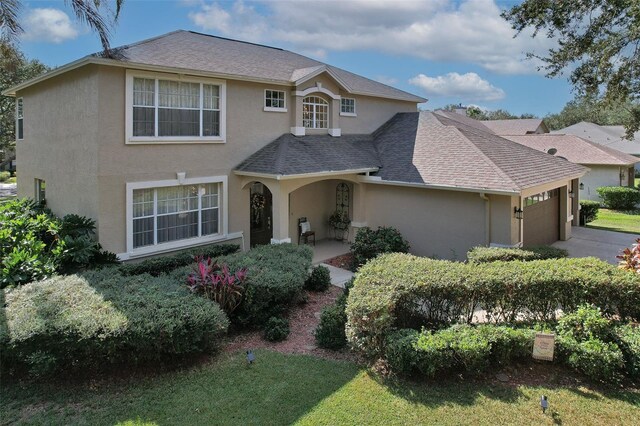 view of property featuring a front lawn