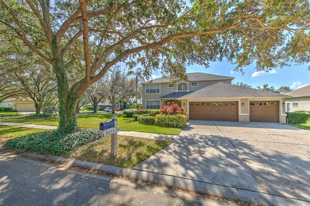 view of front facade with a garage and a front lawn