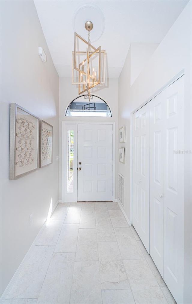 foyer with an inviting chandelier