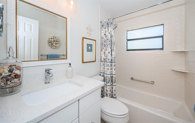 bathroom featuring shower / bath combo, vanity, and toilet