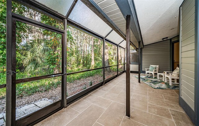 unfurnished sunroom with vaulted ceiling