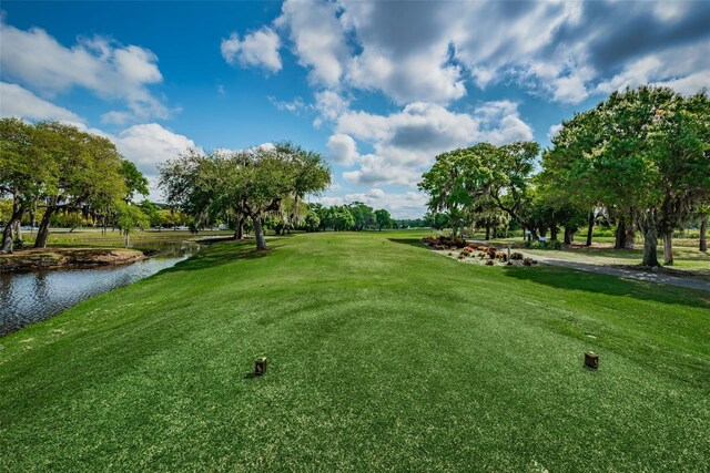 surrounding community featuring a yard and a water view