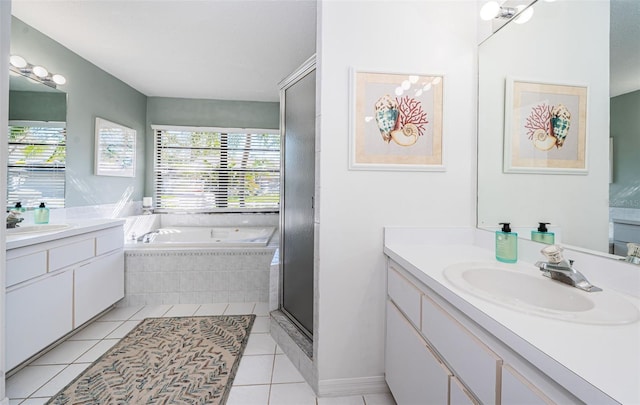 full bathroom featuring a wealth of natural light, a sink, a bath, and tile patterned floors