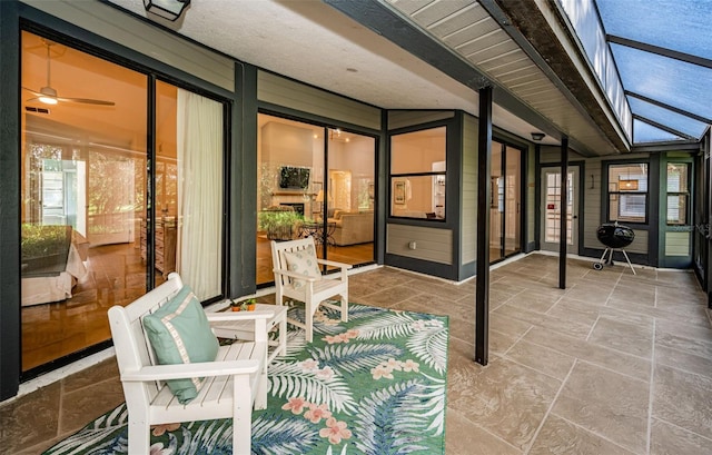 view of patio / terrace featuring glass enclosure