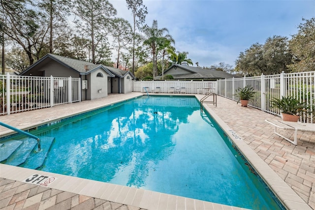 community pool featuring a patio and fence