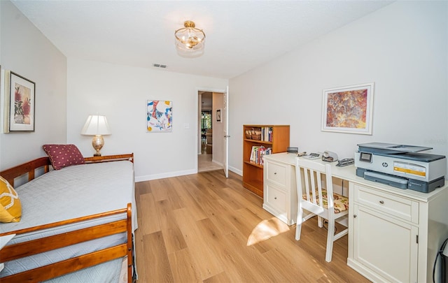 bedroom featuring light wood-type flooring, baseboards, and visible vents