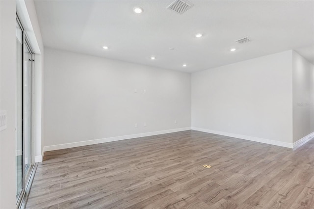 unfurnished room with light hardwood / wood-style floors