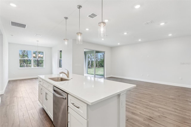 kitchen featuring pendant lighting, a healthy amount of sunlight, and light hardwood / wood-style floors