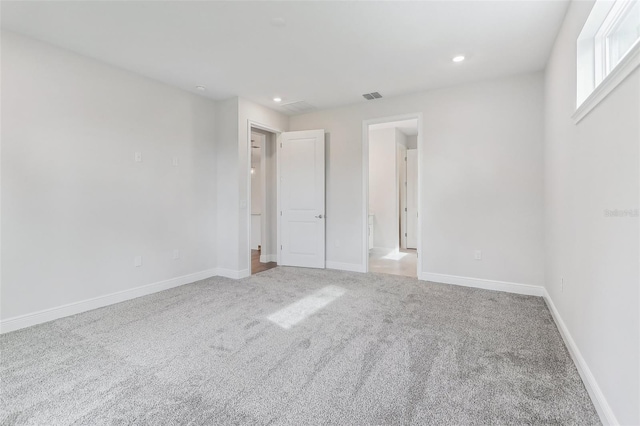 unfurnished bedroom with light colored carpet