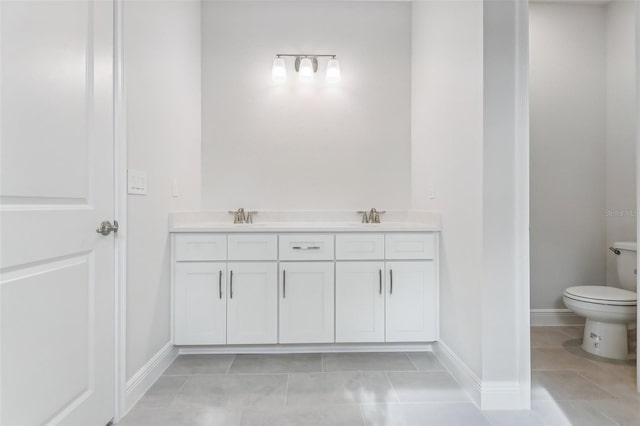 bathroom featuring tile patterned floors, vanity, and toilet