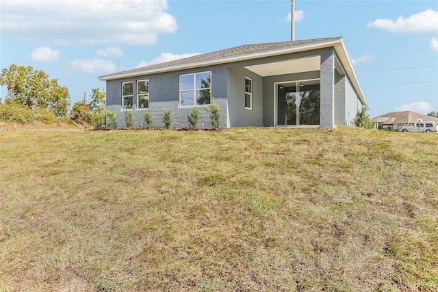 back of house with a yard