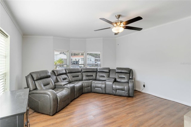 living room featuring hardwood / wood-style floors, ceiling fan, and crown molding