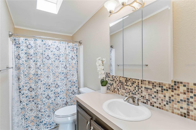 bathroom with vanity, a skylight, decorative backsplash, toilet, and a chandelier