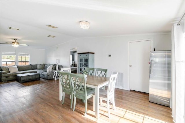 dining room featuring ceiling fan, vaulted ceiling, and hardwood / wood-style flooring