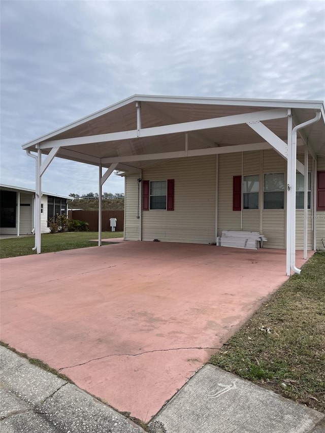 view of car parking with a yard and a carport