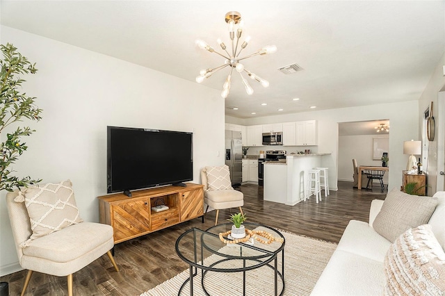 living room featuring dark hardwood / wood-style floors and a notable chandelier