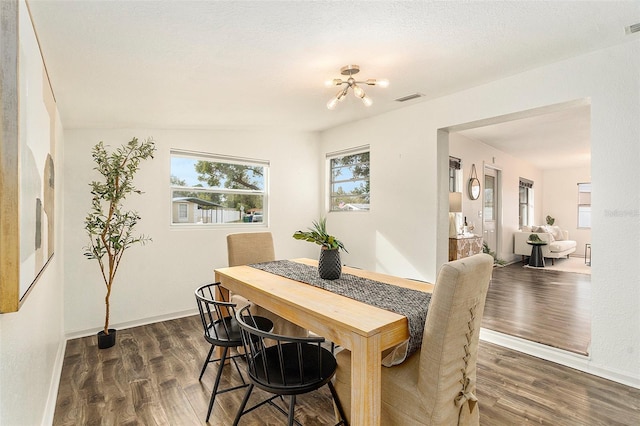 dining room with baseboards, visible vents, and dark wood-style flooring