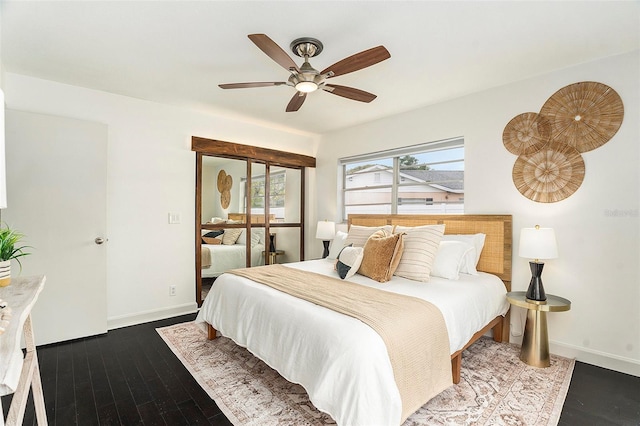 bedroom featuring a ceiling fan, baseboards, and wood finished floors