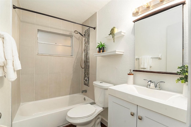 bathroom with toilet, shower / bath combination, a textured wall, and vanity