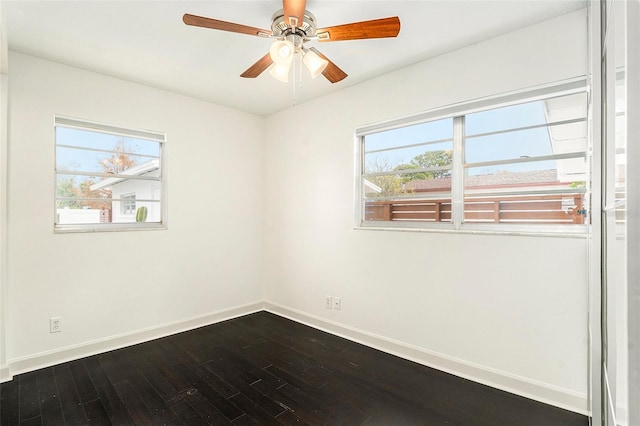 spare room featuring a wealth of natural light, ceiling fan, and wood-type flooring