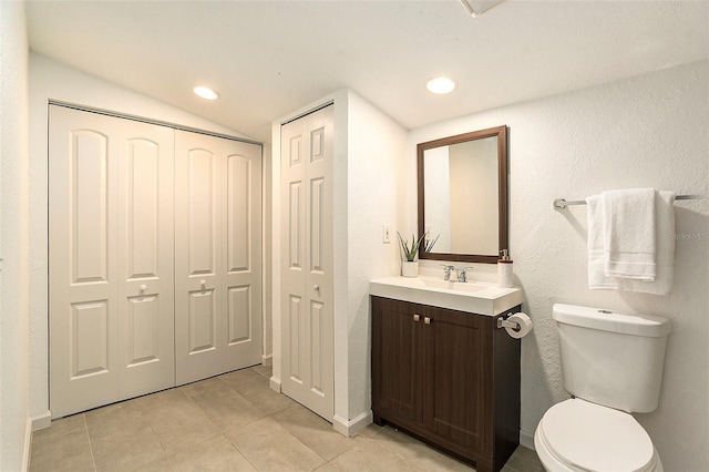 bathroom with toilet, recessed lighting, tile patterned flooring, and vanity