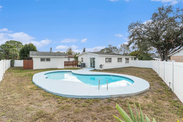 view of swimming pool featuring a fenced backyard, central AC, a fenced in pool, and a yard