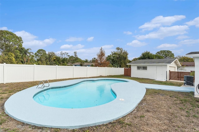 view of pool with a fenced backyard, a fenced in pool, and an outdoor structure